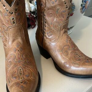 These boots are black star tan leather till orange and yellow stitched